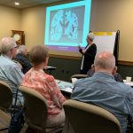 a presenter talks about dementia versus normal aging at a workshop at carrier law in grand rapids, mi
