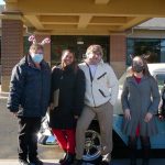 team members of carrier law show their holiday spirit during the cookie and cocoa drive-by